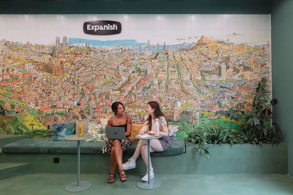 Students siting at spanish school mural