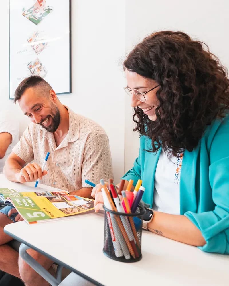 Two adult students at Expanish classroom studying with books