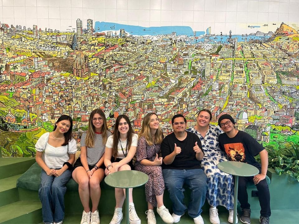 students in front of school mural