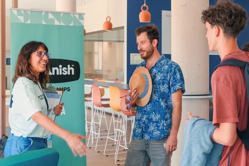 Expanish staff welcoming students during arrival at the summer camp residence common area.