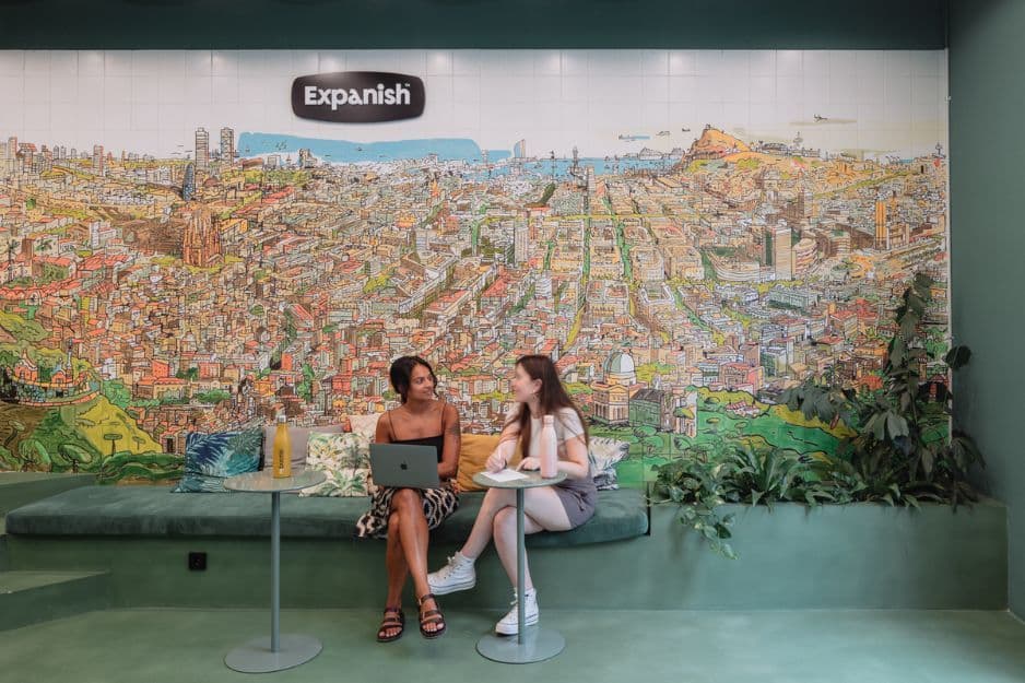 Students siting at spanish school mural