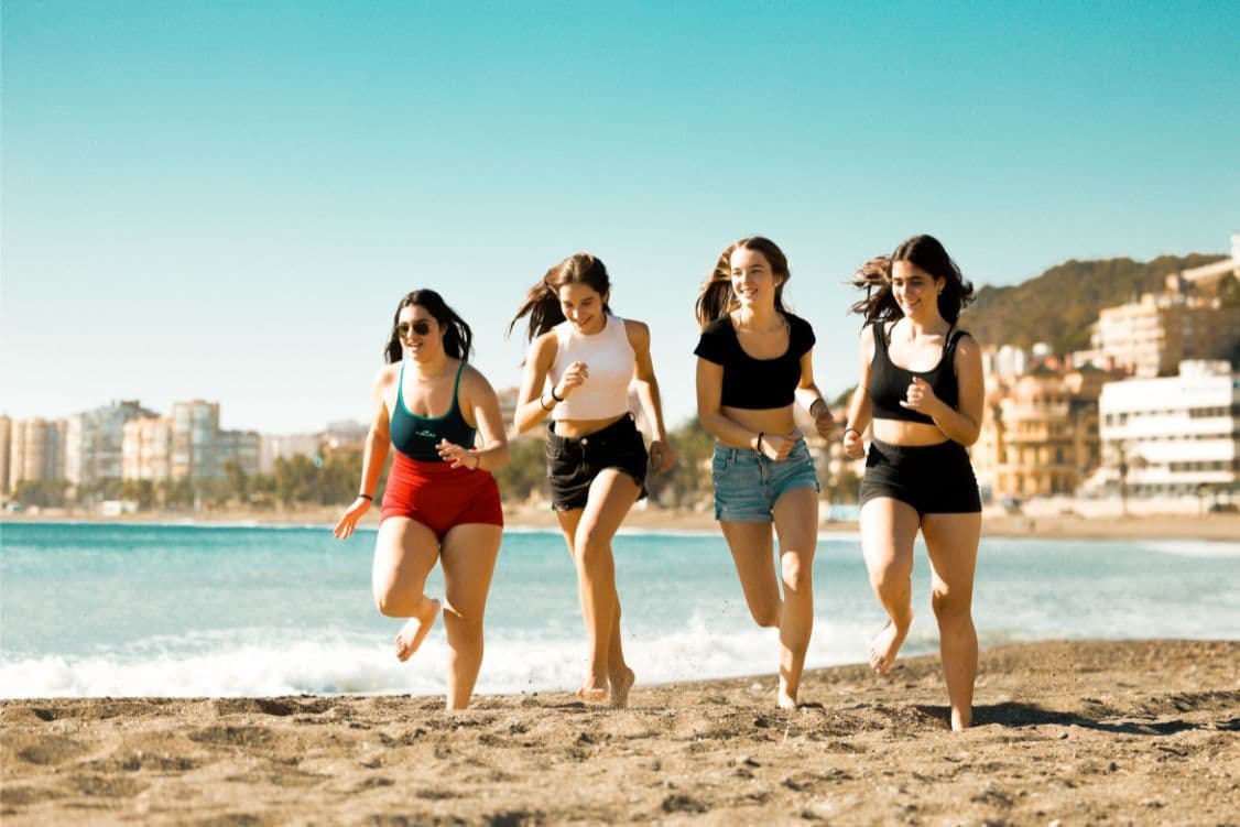 students running at the beach