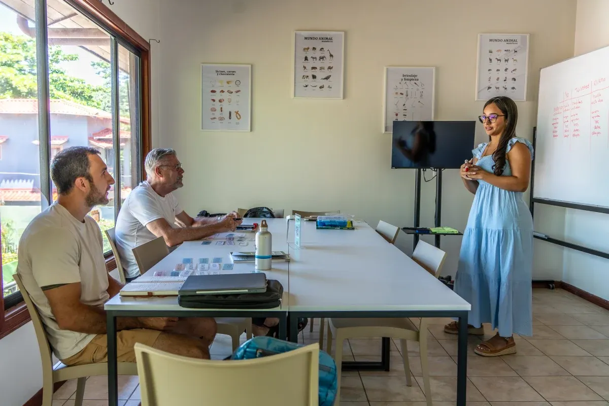 Spanish teacher leading a small group class with two adult students at Expanish Costa Rica