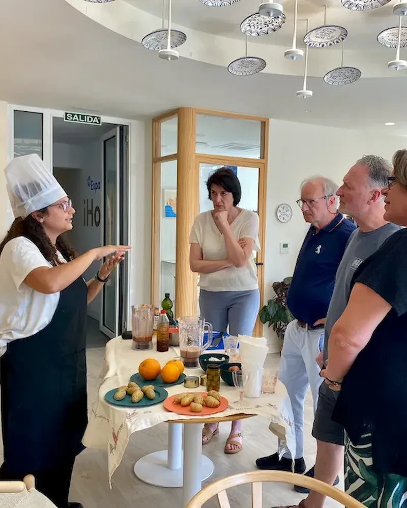 Adult language students enjoying a group cooking workshop
