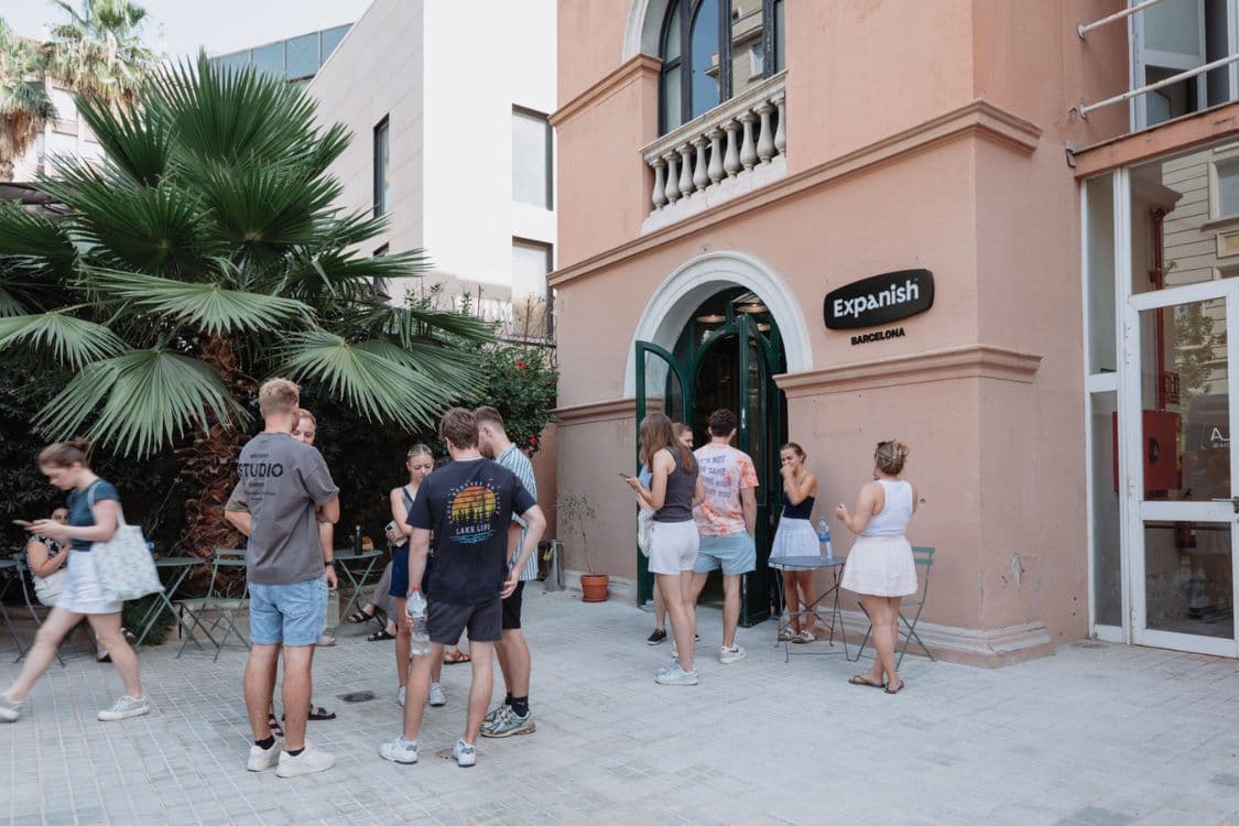 Students standing outside spanish school in the city