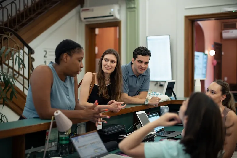 Students talking with staff at the reception desk in Buenos Aires school