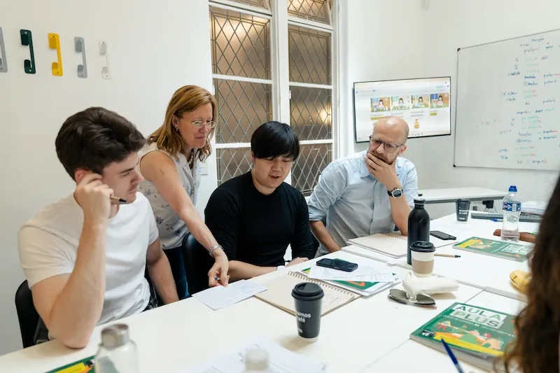 Teacher assisting students during a Spanish class at Expanish Buenos Aires