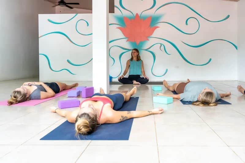 Group of students practicing relaxation poses during an Expanish yoga class in Costa Rica