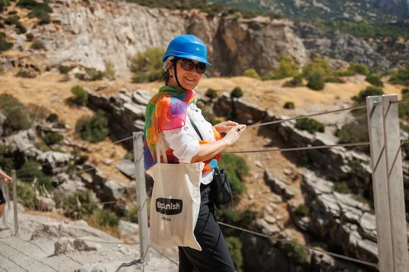 50+ Program student wearing a helmet and enjoying an outdoor excursion near Málaga’s scenic cliffs.