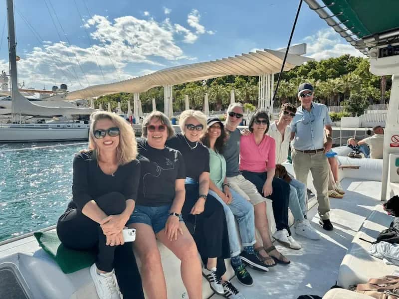 50+ Program students gathered on a boat in Málaga, smiling before a coastal excursion.