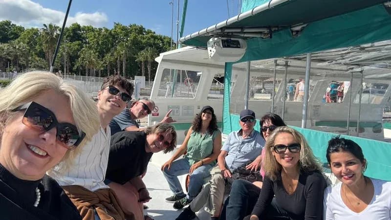50+ Program students relaxing together on a boat in Málaga before a coastal activity.