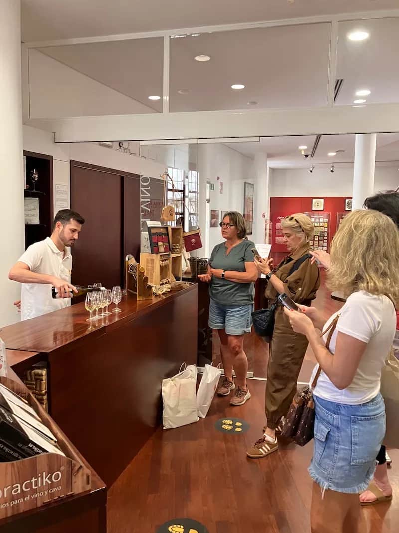 50+ Program students listening to a wine expert during a tasting session in Málaga.