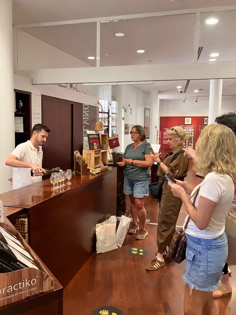 50+ Program students listening to a wine expert during a tasting session in Málaga.