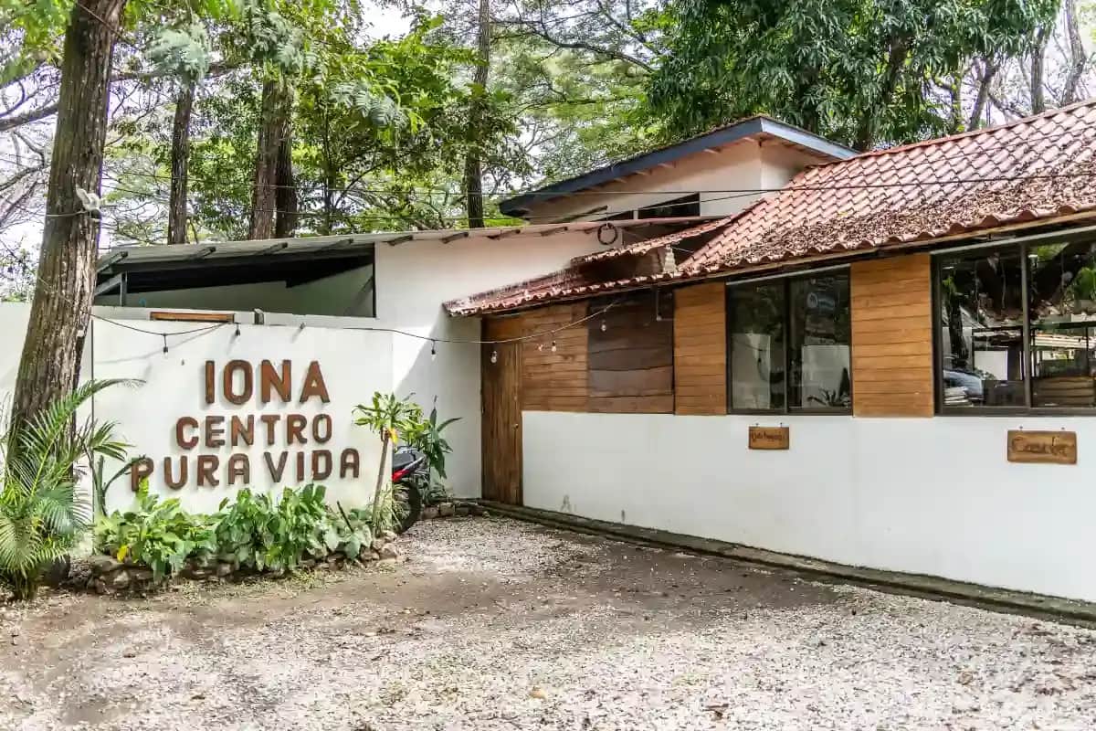 Exterior of IONA Centro Pura Vida Spanish school in Sámara, Costa Rica, surrounded by tropical greenery.