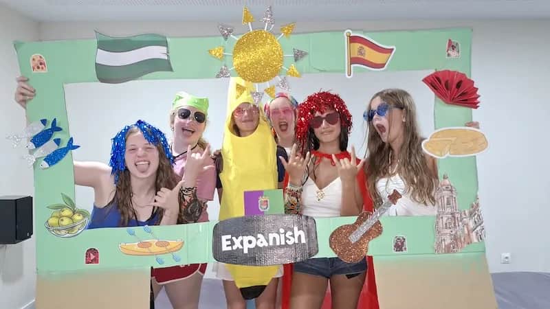 Expanish summer camp students wearing costumes during a cultural activity.