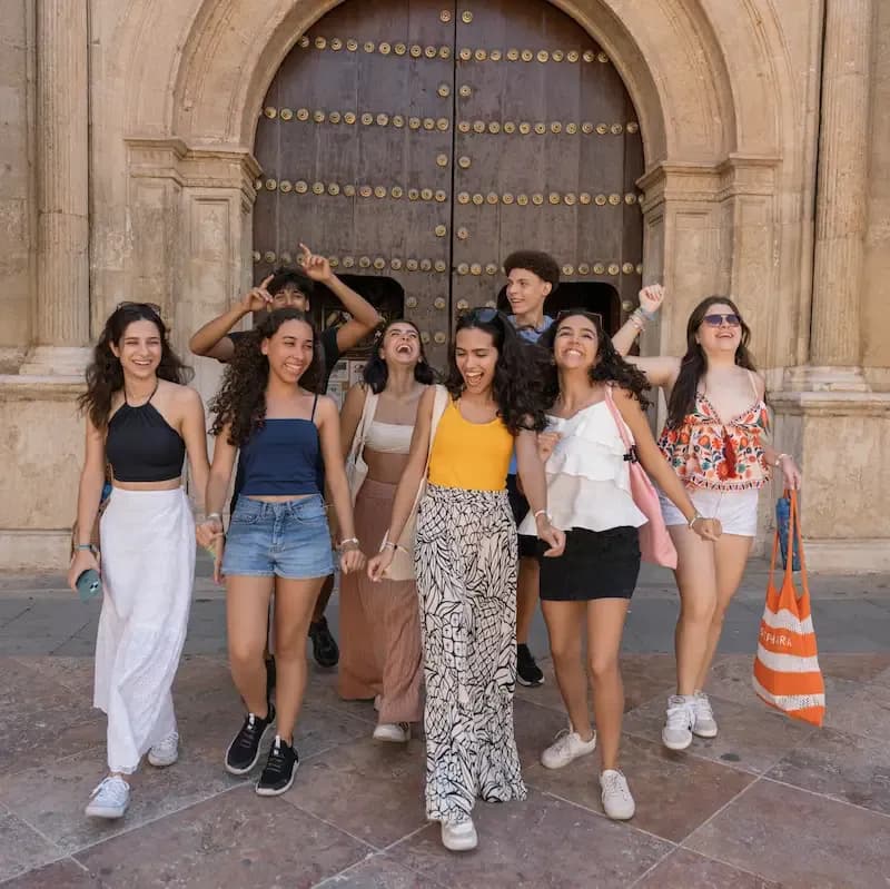 Expanish summer camp students enjoying a city activity while walking together in a historic city center