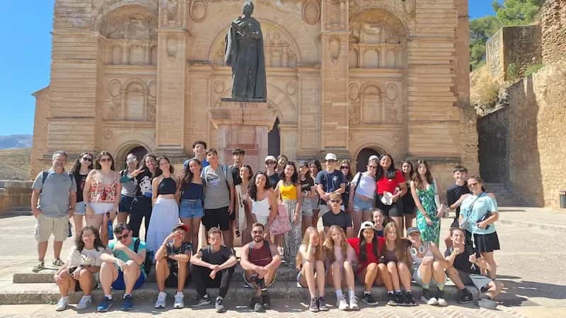 Group of Expanish summer camp students on a city excursion, enjoying an outdoor activity together.