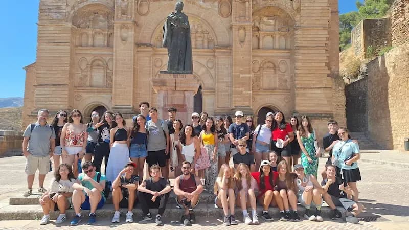 Group of Expanish summer camp students on a city excursion, enjoying an outdoor activity together.