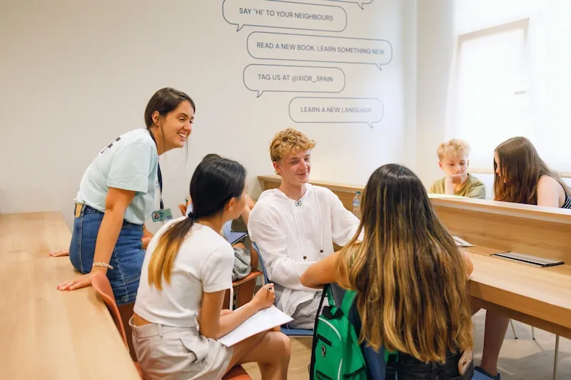 Expanish summer camp students participating in a classroom activity with their instructor.