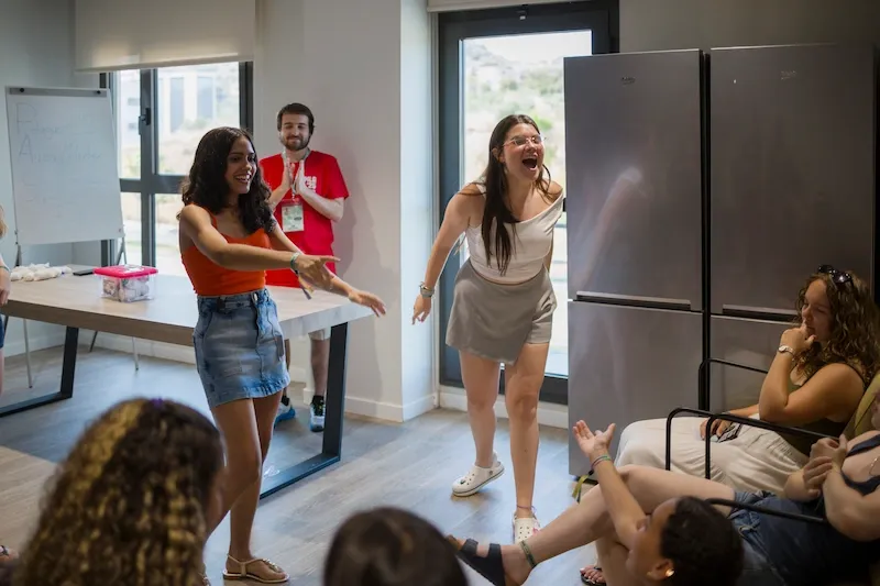 Expanish summer camp students enjoying a lively indoor group activity together.