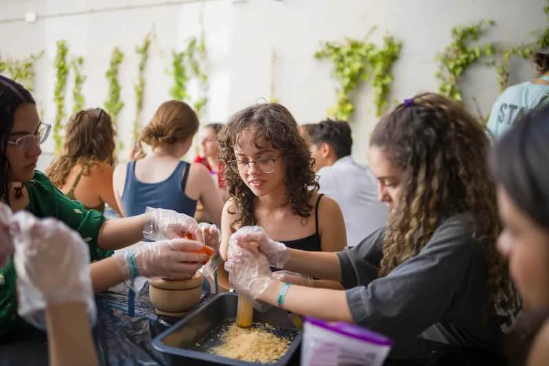 Expanish summer camp students working together in a hands-on life skills workshop.