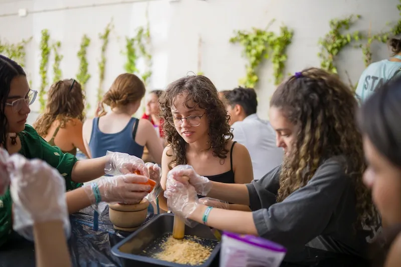 Expanish summer camp students working together in a hands-on life skills workshop.