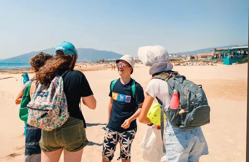 Expanish summer camp students enjoying a beach excursion in Málaga under sunny skies.